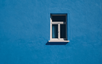 Compact outward-opening style framed against a bold blue wall, combining function with striking visual contrast.